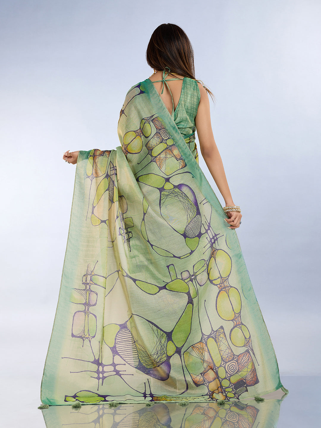 Woman showcasing a Sea Green Linen Cotton Saree with Tassel Pallu and unique abstract patterns.